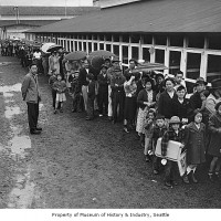 Internees lined up in the rain at Camp Harmony, Puyallup, 1942